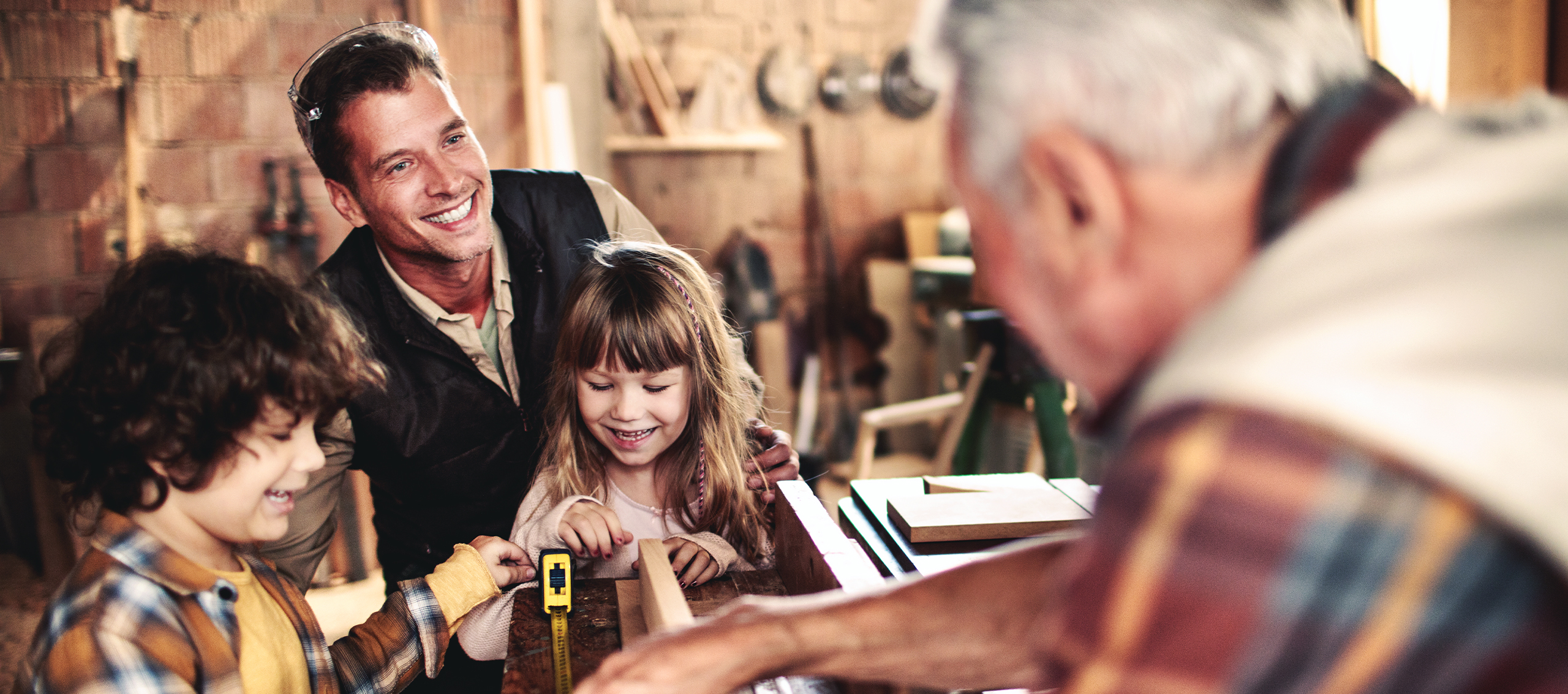 A man with a daughter looking at tools with another older man