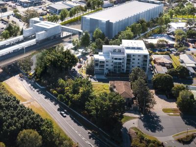 Artist impression of Beenleigh station and park 'n' ride surrounded by roads and buildings.